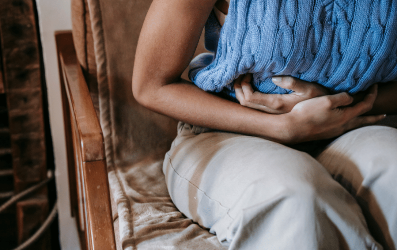 woman clutching her stomach because of IBS