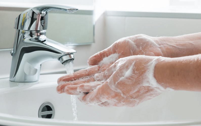 Washing hands in sink